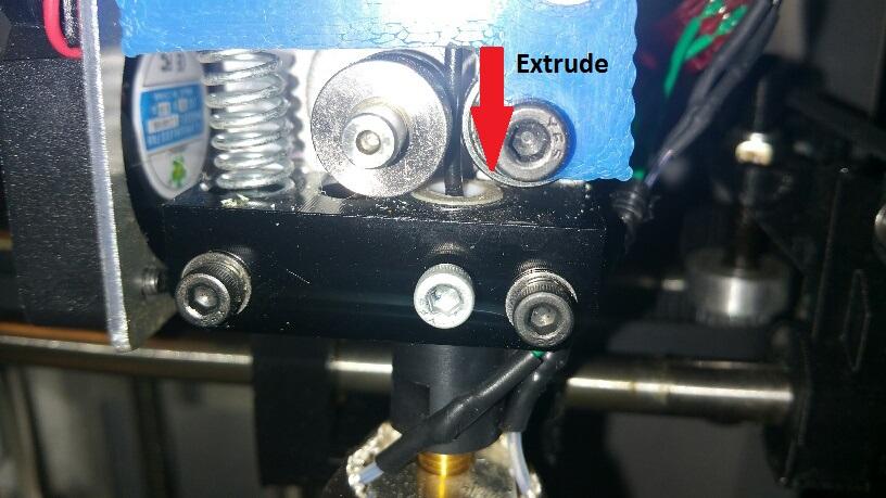 (a) Extrude Direction (b) Plastic Appearing From Nozzle Figure 2.9: Extruding Plastic Through the Nozzle Figure 2.