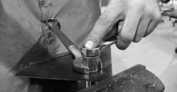 Note: If the correct drill size is not available, it is possible to drill the hole to an available smaller size and slowly grind it out to until the rivet nut fits tight.