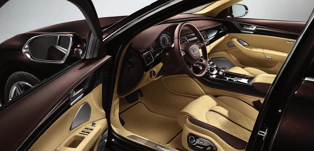 The image shows the Audi A8 L W12 with Audi exclusive customised paint finish in saddle brown, pearl effect; Audi exclusive leather upholstery and trim (package 4) in Valcona