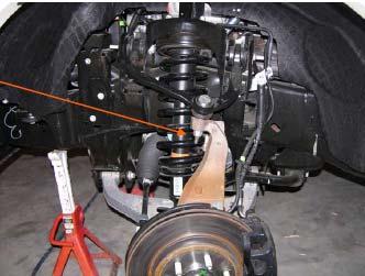 With a pry bar pull down on the upper control arm to install the ball joint