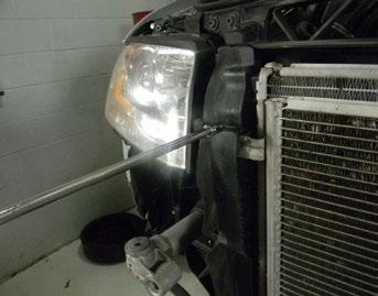 Hang the condenser from bungee cords beneath the car to prevent air conditioning hose damage.