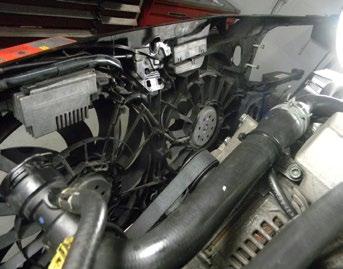 The lower radiator hose and air inlet hose for the charge air cooler must also be disconnected.