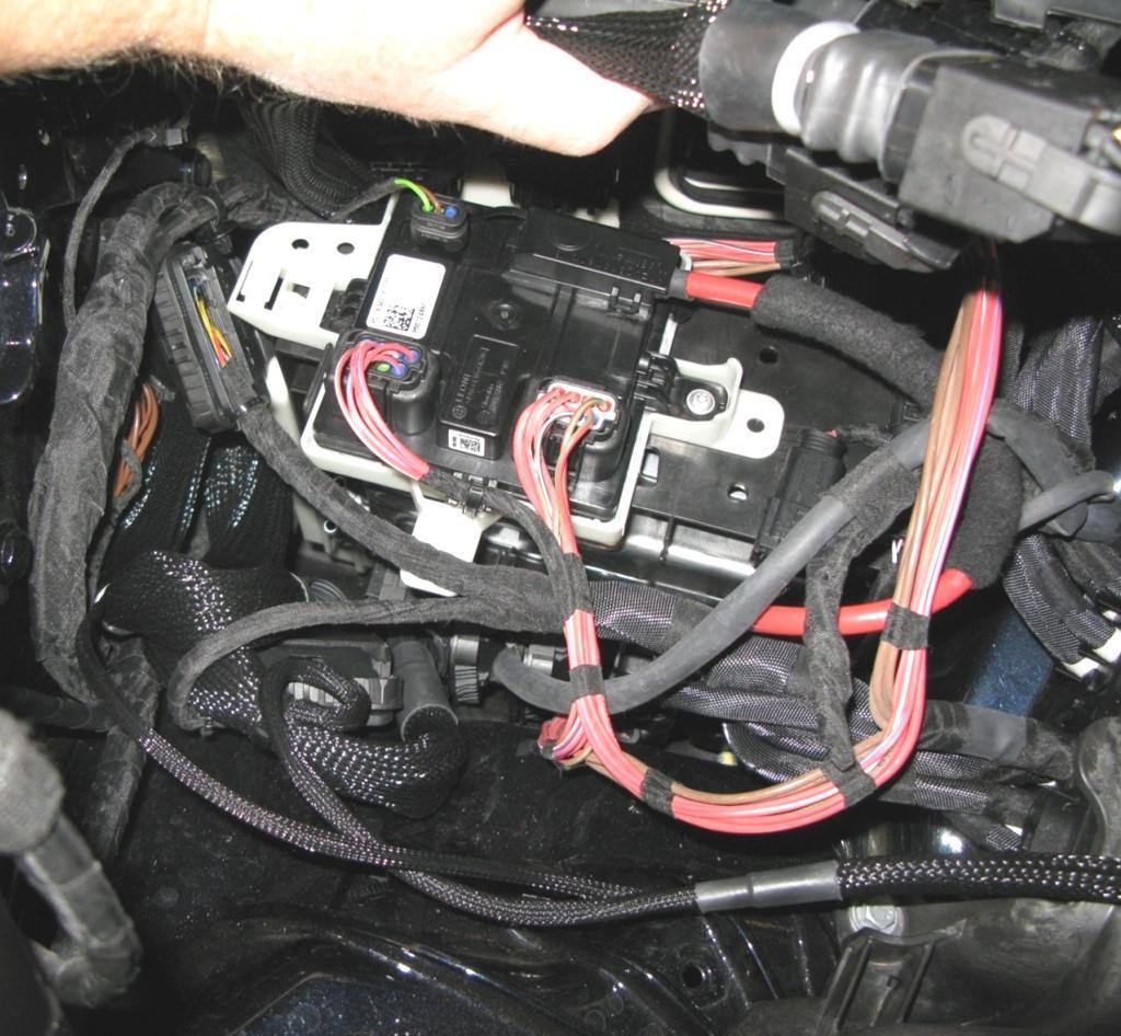 26. Slide the control unit holder down into place while holding up the rear interconnects from Bank 1.