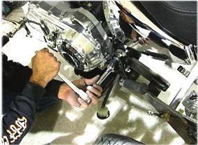 The trike must be sitting on the ground on its suspension to adjust the belt. 18. Tighten jam nut on adjuster bolts.