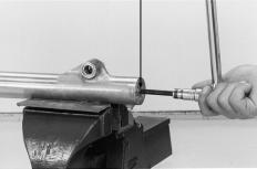 XL200 Hold the fork slider in a vise with piece of woods or shop towel.