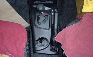 (f) Remove center console upper panel. (1) Remove panel by disengaging 8 clips (Fig. 2-6).