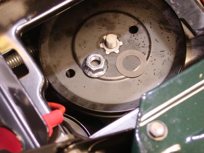 18.13.Using an impact gun with a 7/8 inch socket, remove the flange nut securing the transmission pulley to the transmission. See Figure 31.
