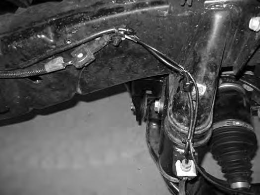 BRAKE LINE / ABS WIRE MODIFICATION 54. Carefully form the brake line to allow the mounting end to attach to the side of the bump stop cup.