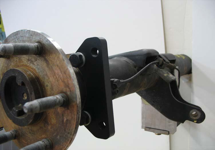 Install the lower caliper mounting bracket onto the axle flange using