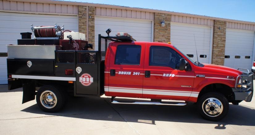 7A - 5-2003 Brush Truck small pump and water tank on a four wheeled vehicle allowing firefighters to