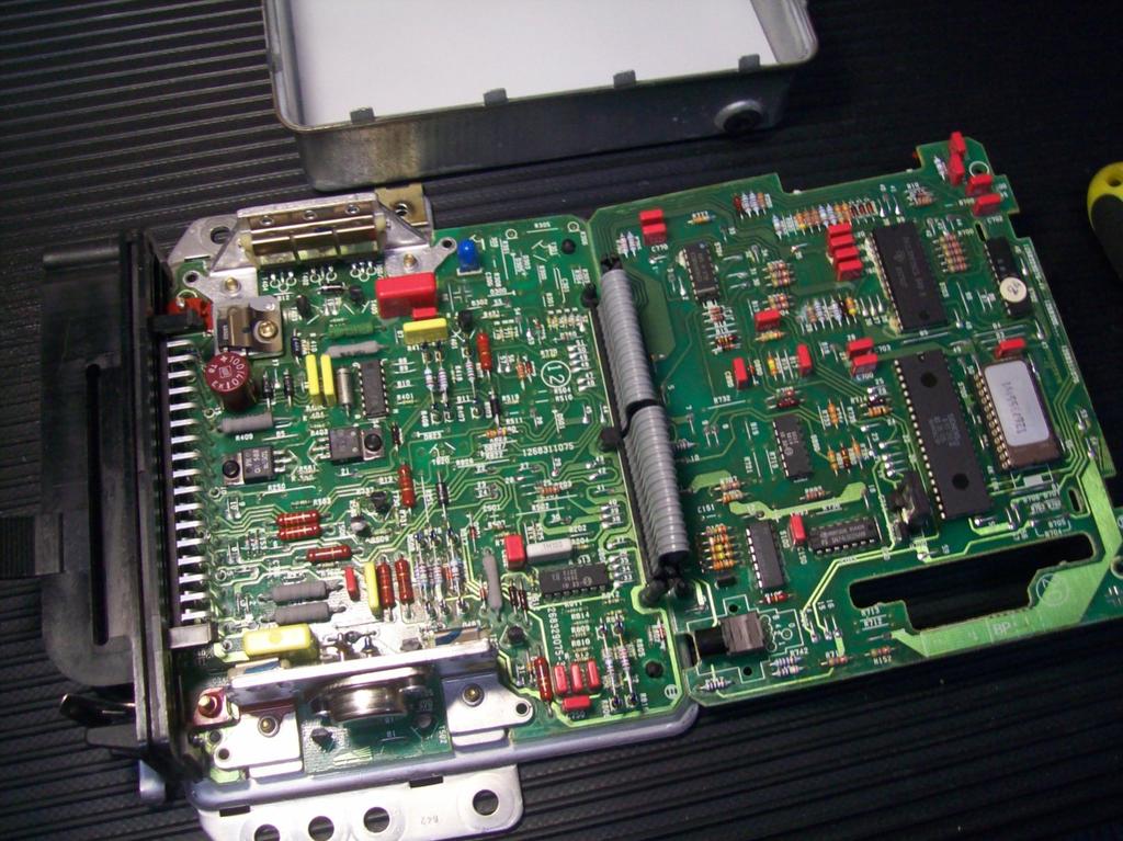 Step 13 - Open up the printed circuit boards so that the components including the DME chip are exposed
