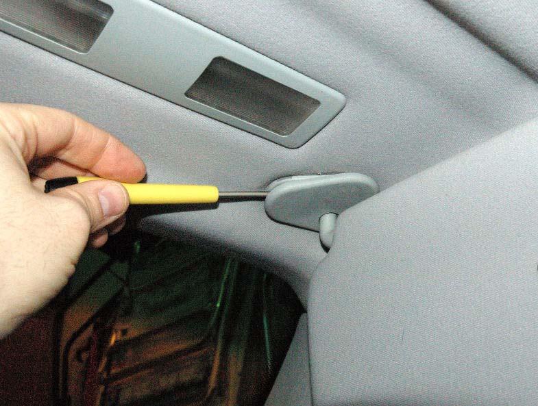 3 Use a small flat blade screwdriver to carefully pry off the plastic cover off the