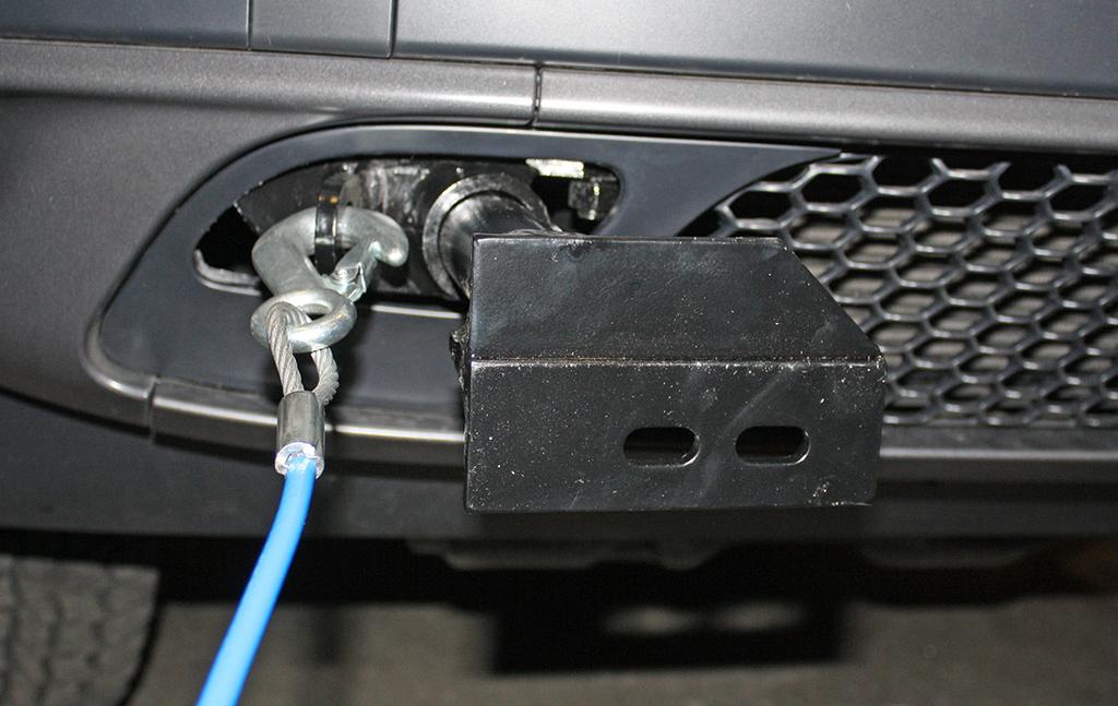 Install the tow bar to the mounting bracket according to the manufacturer's instructions. safety cable tab Fig.Y IMPORTANT! Safety cables are required by law.
