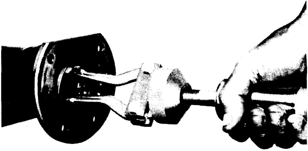Figure 104 1009-104 Using a torque wrench as shown, torque nuts to 25-35 lbs. ft. Assembly brake drums, retainer nuts, wheels, etc. Tool-#C-524-A Torque wrench.