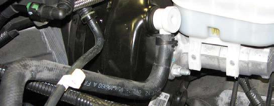 manifold next to the larger brake booster hose.