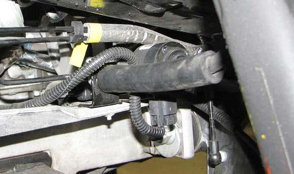 Use a 10mm socket to remove the driver side brake line bracket bolt. 86.