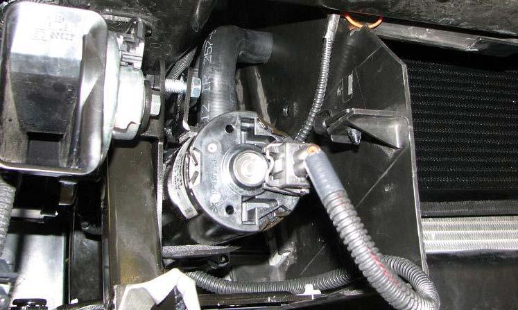Use a 10mm socket and the four stock bolts to reinstall the upper radiator shroud then attach