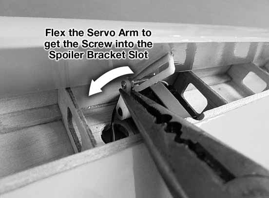 The simplest way to get the screw on the servo arm into the spoiler bracket slot is to use pliers to flex the servo arm as shown.