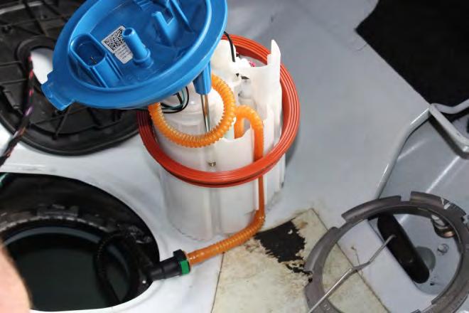 28. Place pump in the position shown in the car and reconnect the fuel line.