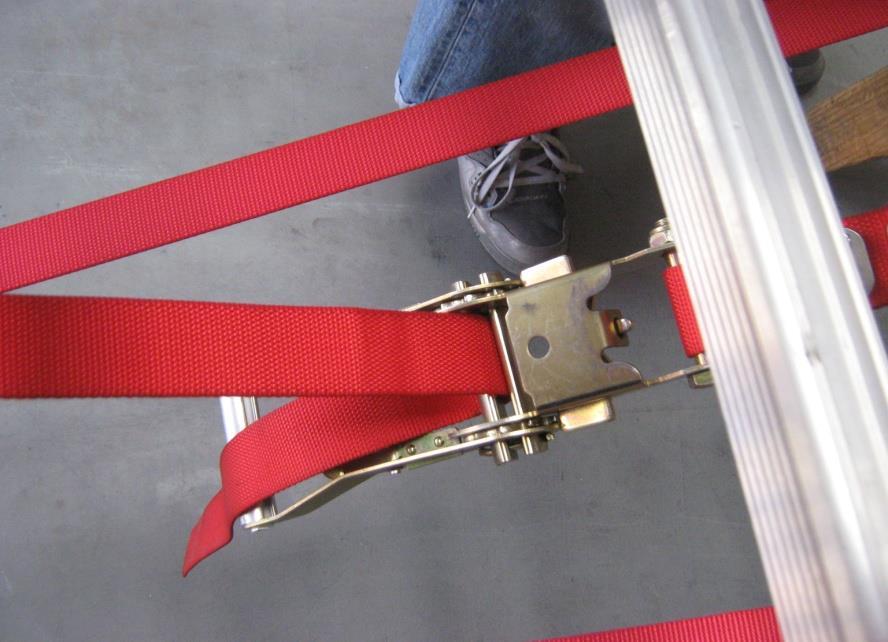 9) Locate the Ratchet Adjustment and the Adjustment Strap on the underside of the ladder.