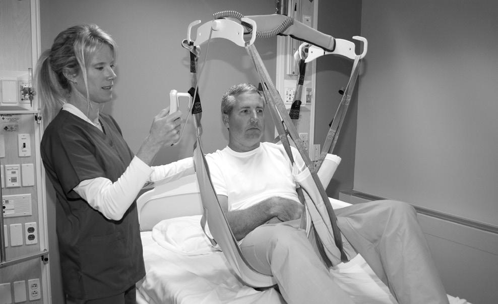 Figure 13 - Lowering to Bed 3) Unhook sling from EZ Way Ceiling Lift and move the lift away from the patient.