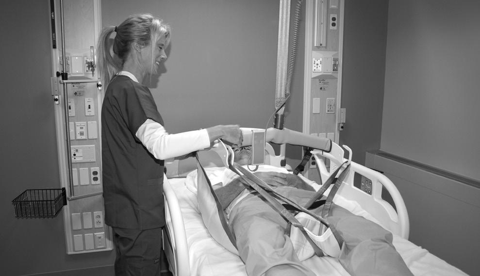 Transferring Patient from Bed to Chair, Wheelchair, or Toilet Step 1 Position Sling under Patient 1) Log roll the patient on his/her side away from you. (See FIG.