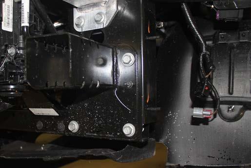 Using a 15MM socket, remove the three (3) bolts from the frame extension and two (2) bolts from the bottom side of the bumper (white).
