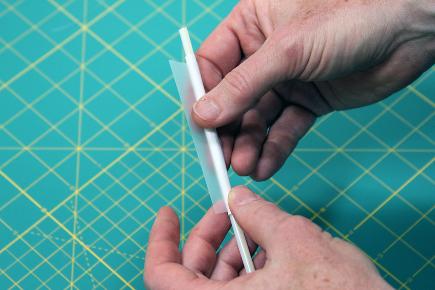 (See, fractions really are useful!) Using a long piece of tape, create three or four fins about an inch long at one end of the rocket. Use scissors to trim them to a fun shape.