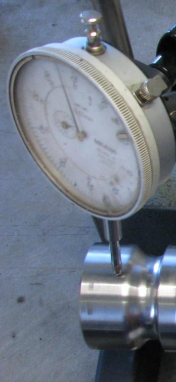 Position dial indicator onto crank as shown above and eliminate main bearing clearance by bearing down on crank when rotating.