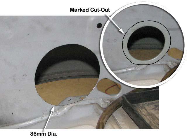 6 Use a body saw to enlarge the hole in the inner guard panel to 86mm diameter (cutting on the outside of the