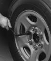 Removing the Flat Tire and Installing the Spare Tire 1. Use the wheel wrench to loosen all the wheel nuts.