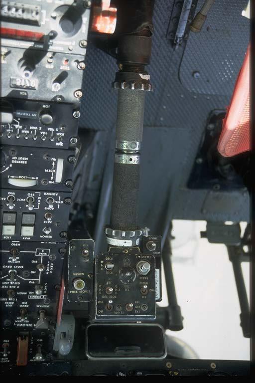 engine shut down becomes a one handed operation. Directly to the right of the IDLE STOP switch is located the three position searchlight switch, SLT - OFF - STOW.