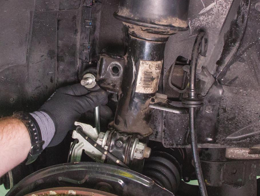 5. DISCONNECT THE SWAY BAR LINK BY REMOVING THE NUT HOLDING THE BALL JOINT TO THE