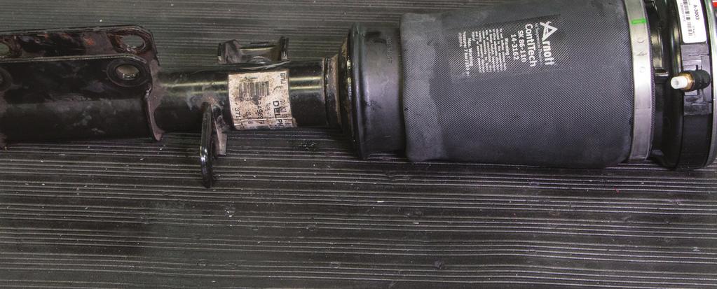 6. SLIDE AIR SLEEVE ASSEMBLY ONTO THE SHOCK UNTIL LOWER PISTON SEATS ONTO THE 2 (TWO) LOWER O-RINGS.