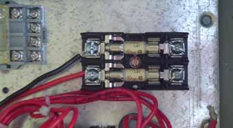 Step 9: The red and black wires from the TVSS are to be connected to the terminals of the TVSS fuse block. Strip 0.25 in. (6.35 mm) of insulation from the end of the wires.