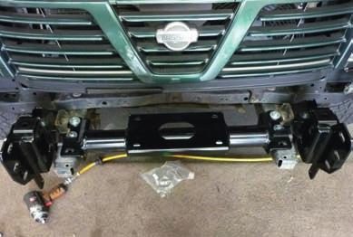 Fit chassis bracket and winch cradle to chassis as shown.