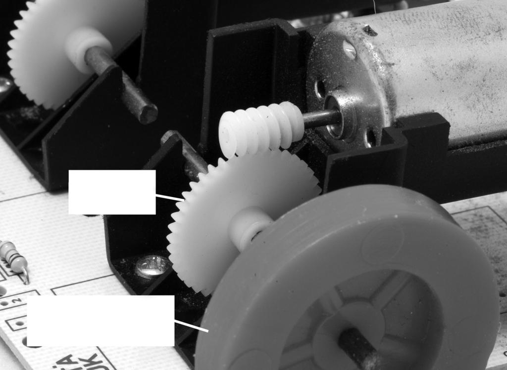 9 Fig. 9 shows part of a small robot vehicle which is driven by two motors, one on either side. 8 45t gear driving wheel Fig. 9 (a) (i) Name the gear system connecting the motor to the driving wheel.