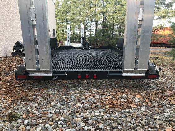both axles, with self-adjusting brakes 12,000 GVWR Trailer de-rated to 9,990 lbs GVWR to meet DOT rules Skid proof heavy duty fenders Heavy duty non-skid mesh deck Overall length: 21 Deck length: 10
