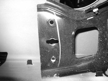 39. There is a slot and hole between the factory mounting holes on the bumper. Drill out the factory hole to 1/2" and do the same in the center of the slot using a drill or rotary grinder.
