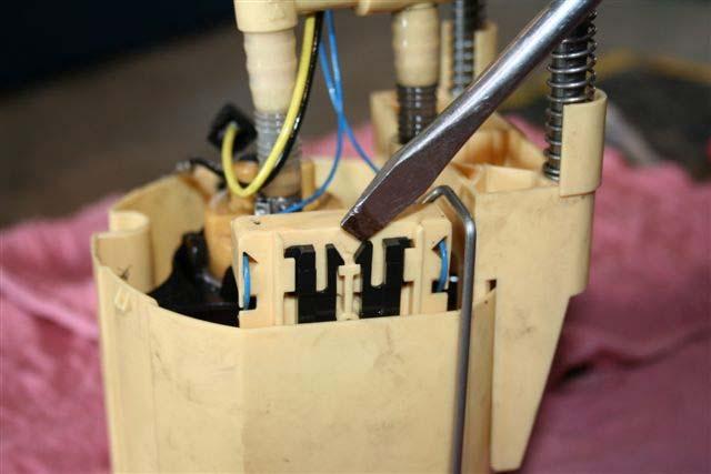 With the basket removed, use a hack saw blade and cut the three supports