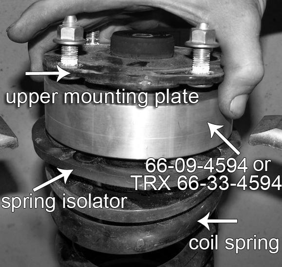 FORM #4605.06-010214 PRINTED IN U.S.A. PAGE 10 OF 19 Remove the strut s upper mounting plate then the factory coil spring isolator. Carefully remove the strut cylinder from the coil spring.