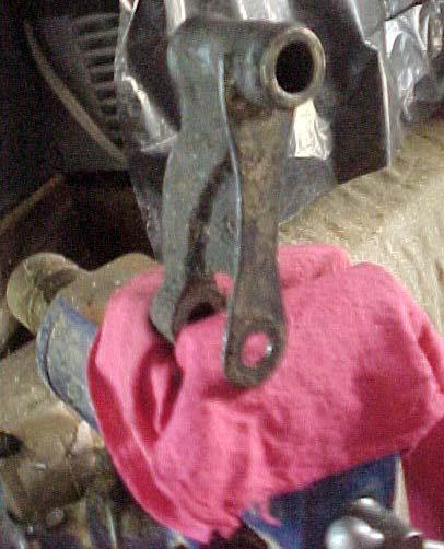 Protect the Finish of the Arm rags or small pieces of wood. Place the idler arm into a vice.