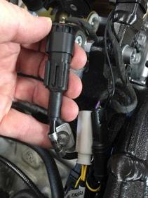 Step 3: Locate the OEM quickshifter and remove: 1) Follow the OEM quickshifter cable up to where it connects to the OEM wiring harness.