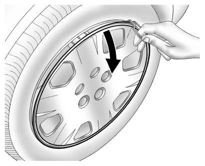 3. Remove the wheel cover, if equipped. 4. Turn the wheel wrench counterclockwise to loosen all the wheel nuts, but do not remove them yet. 5. Place the jack near the flat tire. 6.