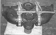 These strainers are frequently furnished with an interlocking chain-drive mechanism so the two valves work in unison (one basket compartment opens while the other is being valved off).