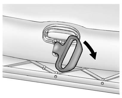 After the convertible top is completely raised, release the convertible top front latch from the lock