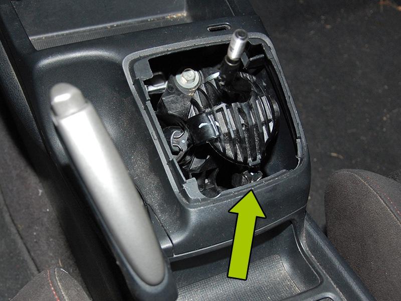 Start by pulling the emergency brake up and unscrewing the shift knob.