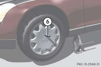 Crank ratchet 5 up and down until the tire is a maximum of 1.2 in (3 cm) off the ground.