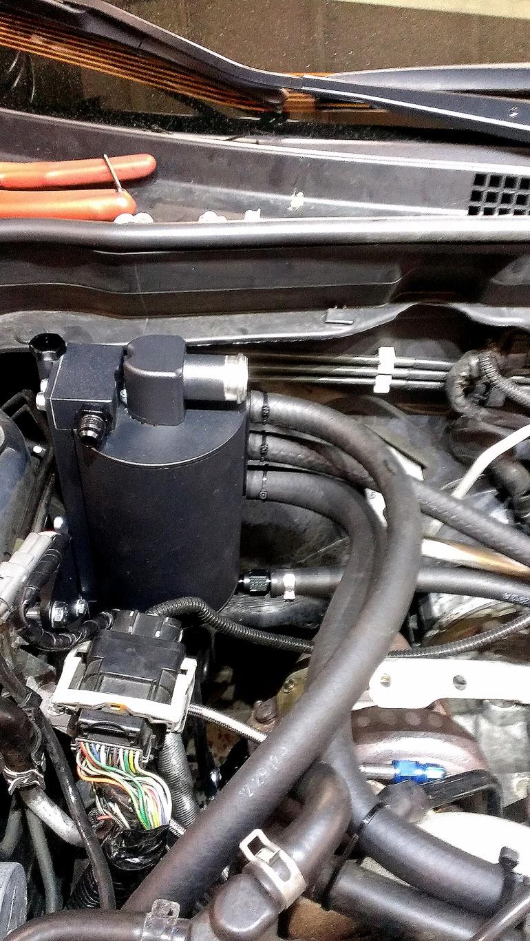 33. Install the valve cover breather hoses by sliding the oil breather hose to the driver s side valve cover port and running the hose to the middle port on the side of the AOS.