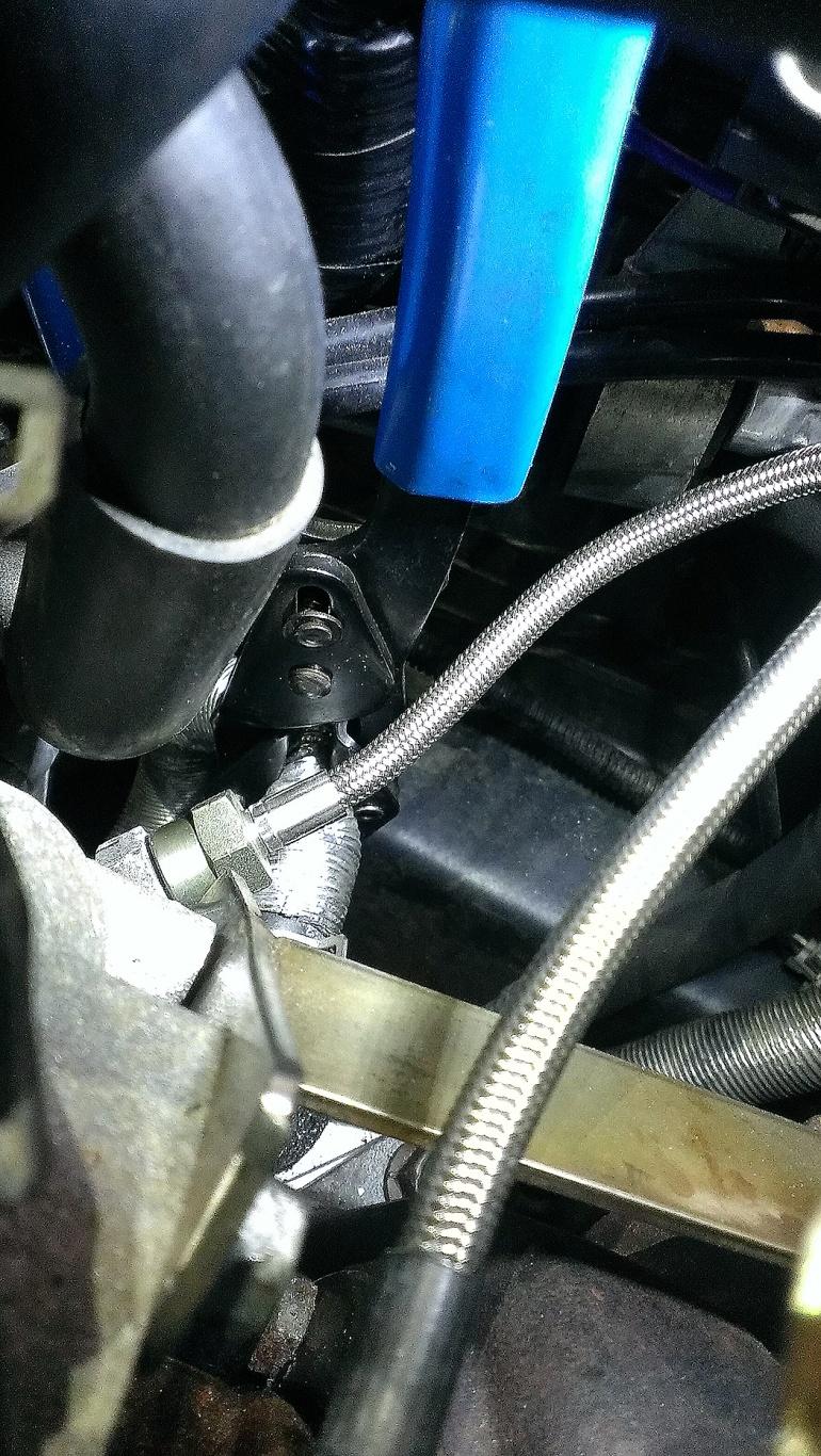 35. Locate the factory lower turbo coolant hose and pinch the hose in the middle so coolant can no longer pass through the hose.